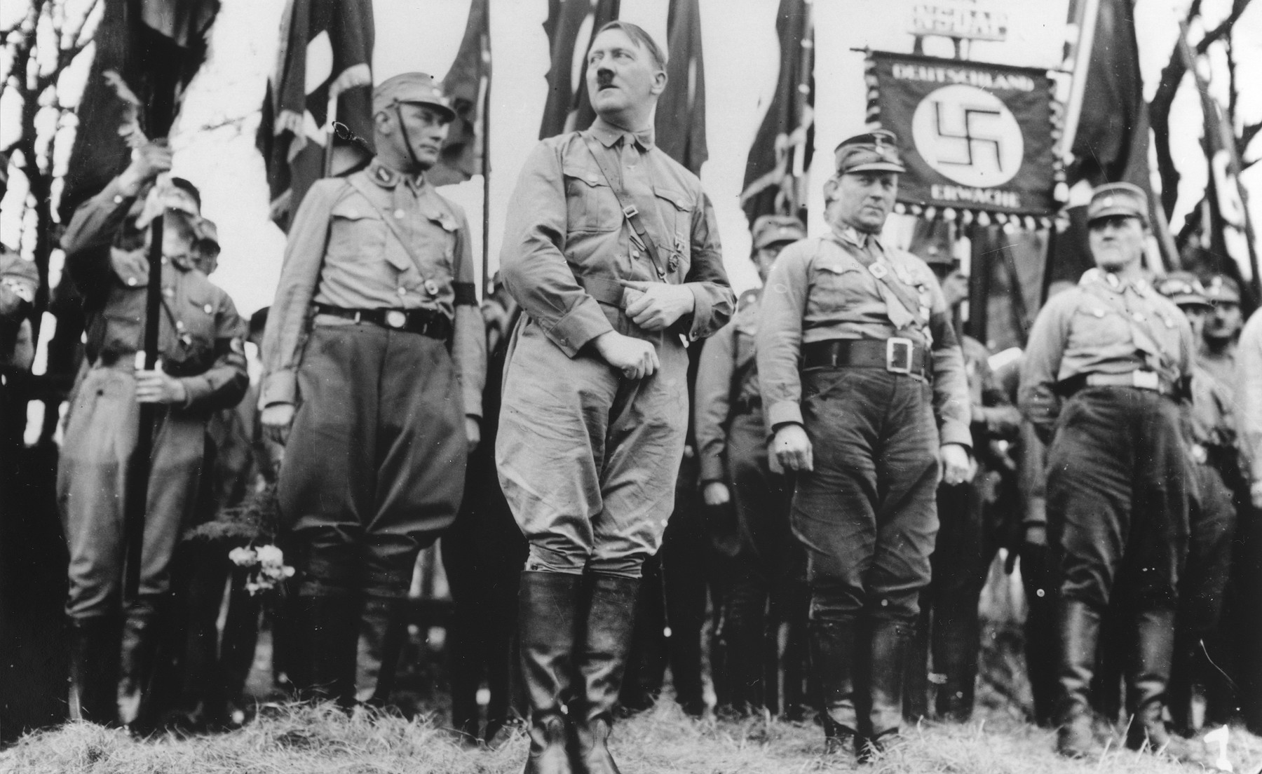 Adolf Hitler stands with an SA unit during a Nazi parade in Weimar